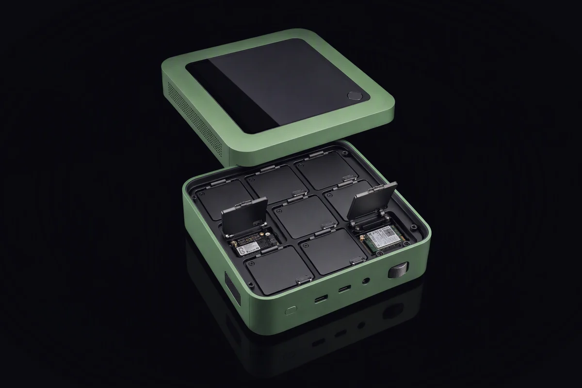 A mini computer from above with its lid off, the inside divided into small sealed compartments, two of them open